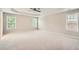Spacious main bedroom featuring plush carpet, tray ceilings, and lots of natural light at 909 Pine Cove Dr, Lilburn, GA 30047