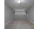 Empty bedroom featuring neutral paint and tile flooring at 1903 Brittania Cir, Woodstock, GA 30188