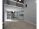 Bright living space with high ceilings, spiral staircase, tiled flooring, and open layout to kitchen at 1903 Brittania Cir, Woodstock, GA 30188