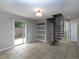 Cozy Gathering room featuring a spiral staircase, built-in shelves, and sliding glass doors to backyard at 1903 Brittania Cir, Woodstock, GA 30188