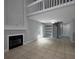 Open-concept living room with fireplace, spiral staircase, built-in shelving, and sliding glass doors at 1903 Brittania Cir, Woodstock, GA 30188