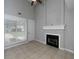 Cozy living room with neutral paint color, large window, tile floors, and modern black fireplace at 1903 Brittania Cir, Woodstock, GA 30188