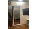 View of the bed alcove, separated by a curtain and including a mounted TV and storage shelf at 20 Marietta Nw St # 10 F, Atlanta, GA 30303