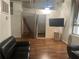 The living room is decorated with a couch, a mounted TV, and wood floors at 20 Marietta Nw St # 10 F, Atlanta, GA 30303