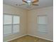 A bedroom features two windows that provide ample natural light and a ceiling fan at 207 Brownlee Sw Rd, Atlanta, GA 30331