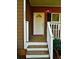 Welcoming front porch with a white door and stairs, adding curb appeal at 207 Brownlee Sw Rd, Atlanta, GA 30331