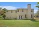 Large, well-maintained backyard with a full view of the rear exterior of the house at 4535 Howell Farms Nw Rd, Acworth, GA 30101
