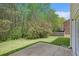 Well-maintained backyard with a lush lawn, patio, and privacy provided by mature trees and landscaping at 4535 Howell Farms Nw Rd, Acworth, GA 30101