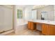 Bright bathroom featuring double sink vanity, soaking tub, and a separate shower with glass door at 4535 Howell Farms Nw Rd, Acworth, GA 30101
