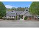 Community clubhouse featuring well-maintained landscaping, an American flag, and ample parking at 4535 Howell Farms Nw Rd, Acworth, GA 30101