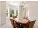 Elegant dining room with bay window, decorative chandelier and wainscoting at 4535 Howell Farms Nw Rd, Acworth, GA 30101