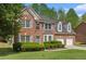 Beautiful two-story brick home with a well-manicured front lawn and a two-car garage at 4535 Howell Farms Nw Rd, Acworth, GA 30101