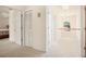 Upstairs hallway featuring plush carpeting, multiple bedroom doors, and a lovely arched window at 4535 Howell Farms Nw Rd, Acworth, GA 30101
