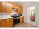 Bright kitchen with stainless steel appliances and wood cabinets open to dining area at 4535 Howell Farms Nw Rd, Acworth, GA 30101