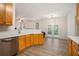 Bright, open kitchen featuring stainless steel appliances and natural wood cabinets, with an adjacent dining area at 4535 Howell Farms Nw Rd, Acworth, GA 30101