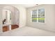 Bright, carpeted living room with large window and arched doorway to foyer at 4535 Howell Farms Nw Rd, Acworth, GA 30101