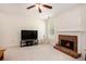 Comfortable living room features brick fireplace, ceiling fan, and neutral carpet at 4535 Howell Farms Nw Rd, Acworth, GA 30101