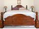 Large, traditional main bedroom with a beautiful wooden bed and clean white linens at 4535 Howell Farms Nw Rd, Acworth, GA 30101