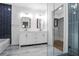 Modern bathroom with double vanity, walk-in shower, and navy blue accent tiling at 1321 Avon Sw Ave, Atlanta, GA 30310