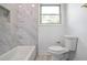 Bathroom features bathtub and shower combination with tile surround at 1321 Avon Sw Ave, Atlanta, GA 30310