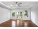 Light filled main bedroom with a tray ceiling, ceiling fan and French doors to deck at 1321 Avon Sw Ave, Atlanta, GA 30310
