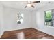 Bedroom featuring hardwood floors, a ceiling fan, and dual window views at 1321 Avon Sw Ave, Atlanta, GA 30310
