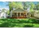 Charming home with a covered front porch and a lush green lawn at 1321 Avon Sw Ave, Atlanta, GA 30310