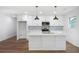 A modern kitchen with a center island, stylish pendants, and stainless steel appliances at 1321 Avon Sw Ave, Atlanta, GA 30310