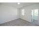A bright bedroom with neutral gray carpet and white walls, creating a serene and clean living space at 2260 Siskin Square Rd # 90, Duluth, GA 30096