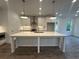 A well-lit kitchen featuring a center island, stainless steel appliances and sleek white cabinetry at 2260 Siskin Square Rd # 90, Duluth, GA 30096