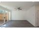 Bright living room with wood floors, modern ceiling fan, and sliding door access to the outdoor deck at 2260 Siskin Square Rd # 90, Duluth, GA 30096