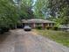 Traditional brick home with manicured lawn, showcasing classic curb appeal in a serene, tree-lined setting at 2985 Laguna Dr, Decatur, GA 30032