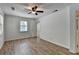 Bright bedroom featuring wood floors, a window, closet space, and a ceiling fan at 4278 Trotters Ln, Auburn, GA 30011