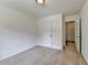 This carpeted bedroom has neutral walls with white trim, closet and open door to a small room at 4278 Trotters Ln, Auburn, GA 30011