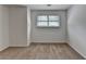 This carpeted bedroom features neutral walls and a window with blinds that fills the space with natural light at 4278 Trotters Ln, Auburn, GA 30011