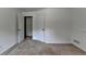 This carpeted bedroom has neutral walls with white trim and a closet at 4278 Trotters Ln, Auburn, GA 30011