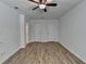 Spacious bedroom with ceiling fan, wood flooring, closet doors, and access to an ensuite bathroom at 4278 Trotters Ln, Auburn, GA 30011