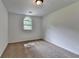 This carpeted bedroom features neutral walls and an arched window that fills the space with natural light at 4278 Trotters Ln, Auburn, GA 30011