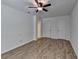 Spacious bedroom with ceiling fan, wood flooring, closet doors, and access to an ensuite bathroom at 4278 Trotters Ln, Auburn, GA 30011