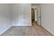 This carpeted bedroom has neutral walls with white trim, an open door and closet at 4278 Trotters Ln, Auburn, GA 30011