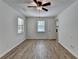 Bedroom featuring wood flooring, ceiling fan, windows, and closet space at 4278 Trotters Ln, Auburn, GA 30011