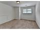 This carpeted bedroom features neutral walls, a window with blinds, and a flush mount light fixture at 4278 Trotters Ln, Auburn, GA 30011