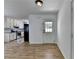 Bright entryway leading to a modern kitchen with white cabinets, subway tile, and stainless steel appliances at 4278 Trotters Ln, Auburn, GA 30011