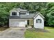 Charming two-story home with a well-manicured lawn, garage, and classic architectural details at 4278 Trotters Ln, Auburn, GA 30011