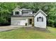 Charming two-story home with a well-manicured lawn, garage, and classic architectural details at 4278 Trotters Ln, Auburn, GA 30011