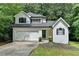 Charming two-story home with a well-manicured lawn, garage, and classic architectural details at 4278 Trotters Ln, Auburn, GA 30011