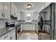 Bright kitchen boasts granite countertops, subway tile backsplash, and stainless steel appliances at 4278 Trotters Ln, Auburn, GA 30011