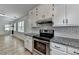 Updated kitchen featuring stainless steel oven, granite countertops and subway tile backsplash at 4278 Trotters Ln, Auburn, GA 30011