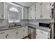 Bright kitchen featuring white cabinets, granite countertops, stainless steel appliances, and tile backsplash at 4278 Trotters Ln, Auburn, GA 30011