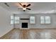 Inviting living room with a fireplace, wood floors, ceiling fan and bright natural light at 4278 Trotters Ln, Auburn, GA 30011